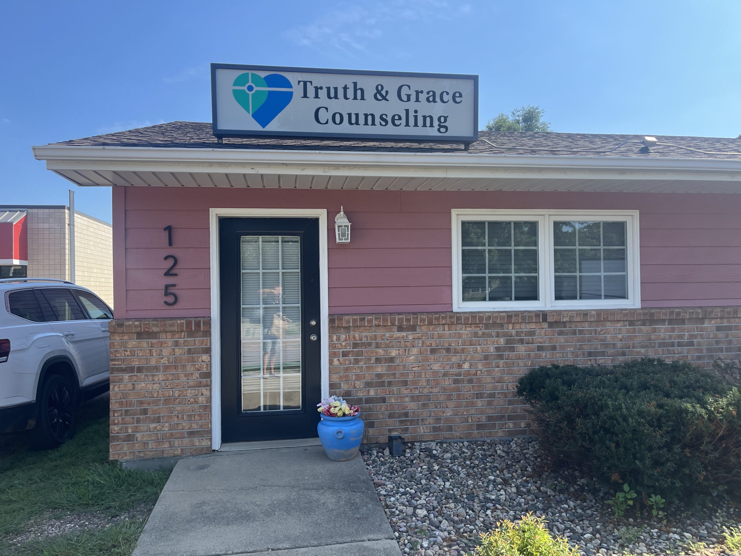 A two-story residential home with blue siding and white trim, featuring a front porch and an attached single-car garage, located at 1409 S Norton Ave, Sioux Falls, SD.