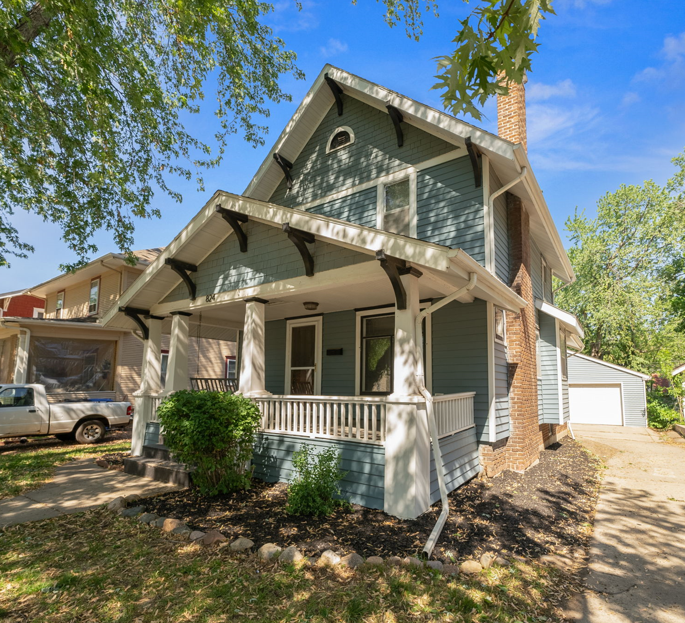 A two-story residential home with blue siding and white trim, featuring a front porch and an attached single-car garage, located at 1409 S Norton Ave, Sioux Falls, SD.