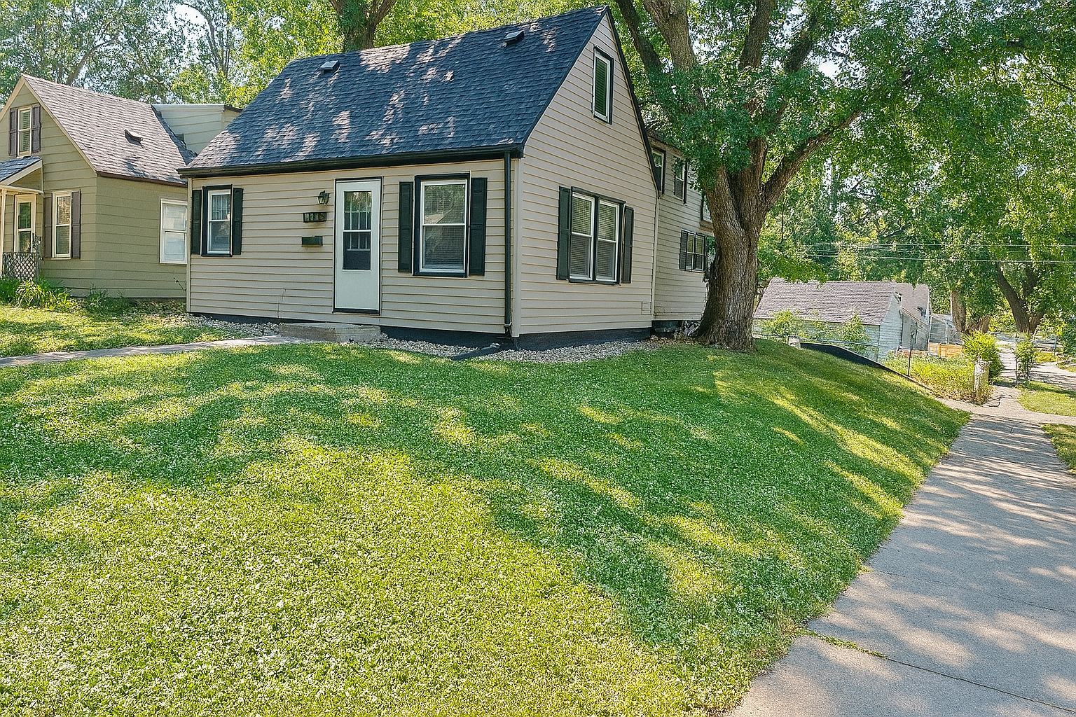 A modern two-story home with gray siding, white trim, and a covered front entrance, alongside a detached two-car garage, located at 710 S Dakota Ave, Sioux Falls, SD.