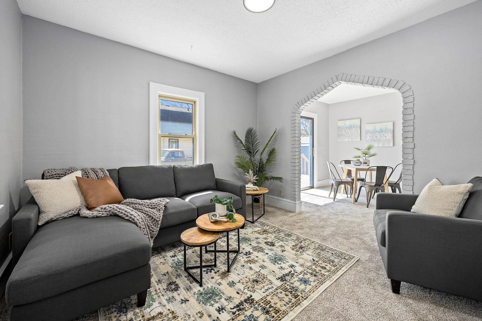 039A0673 Two-story house with beige siding and covered porch at 830 W 7th St, Sioux Falls, SD during early evening